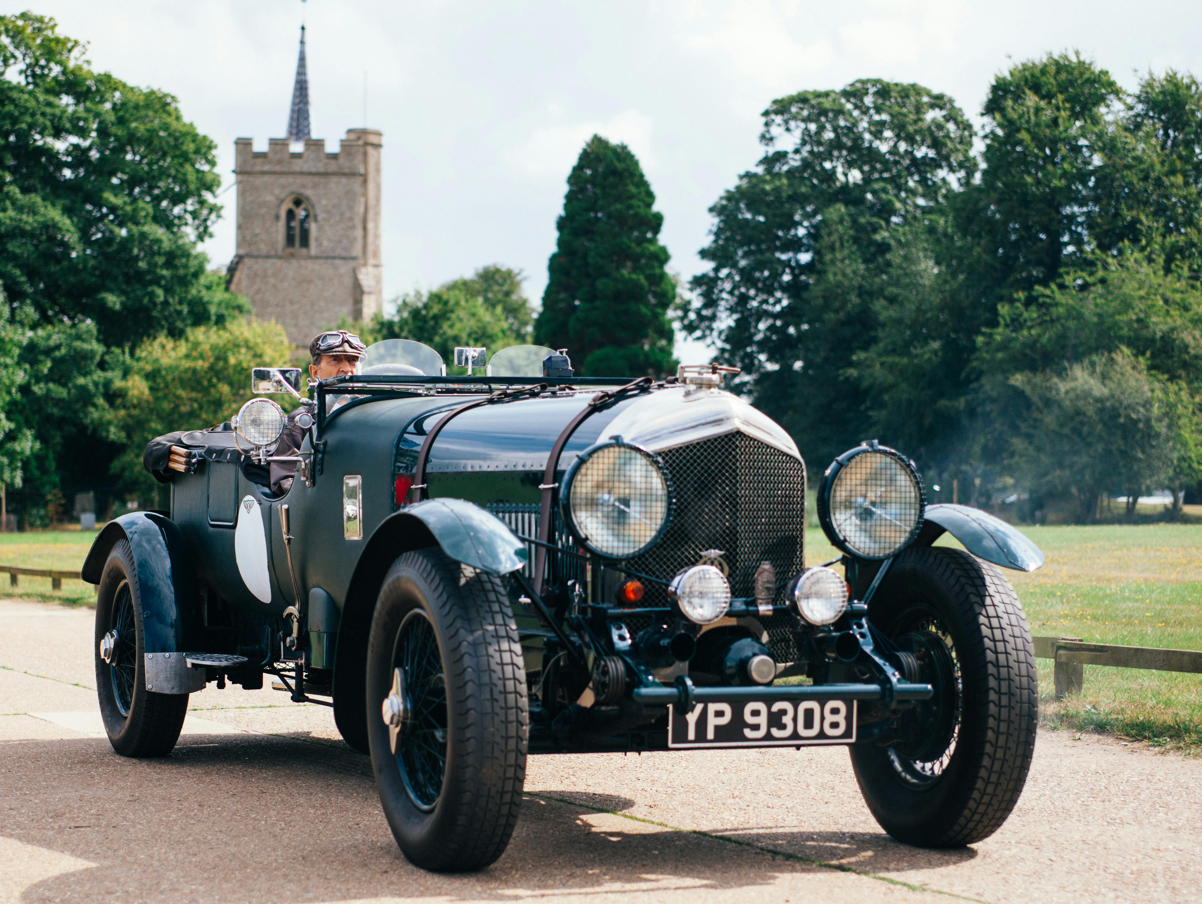 classic old car with castle in the background