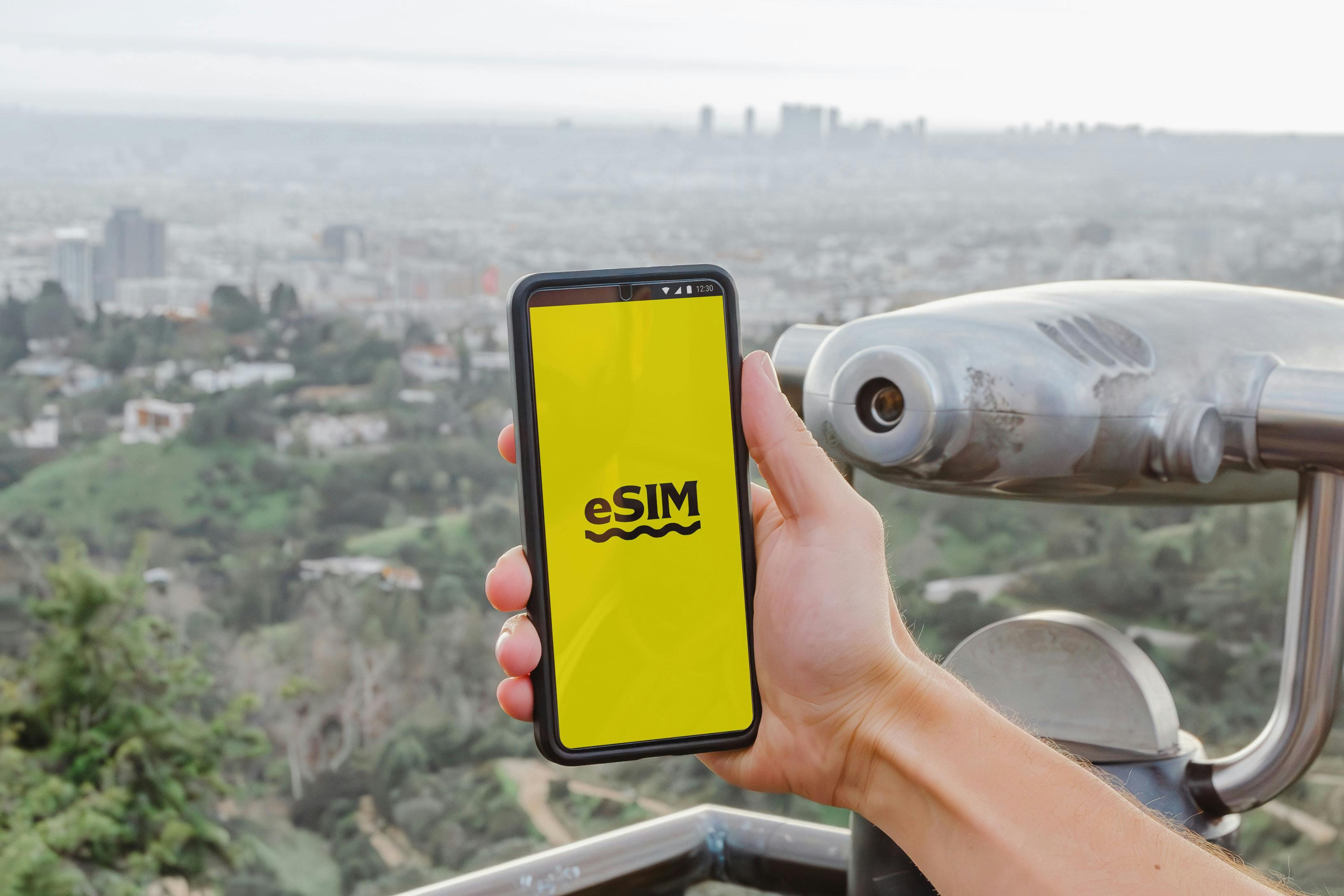 Phone with eSIM for international travel looking over a skyline